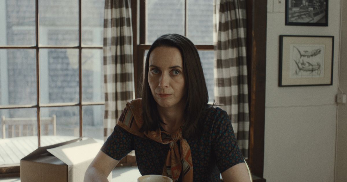 woman having coffee wearing a scarf