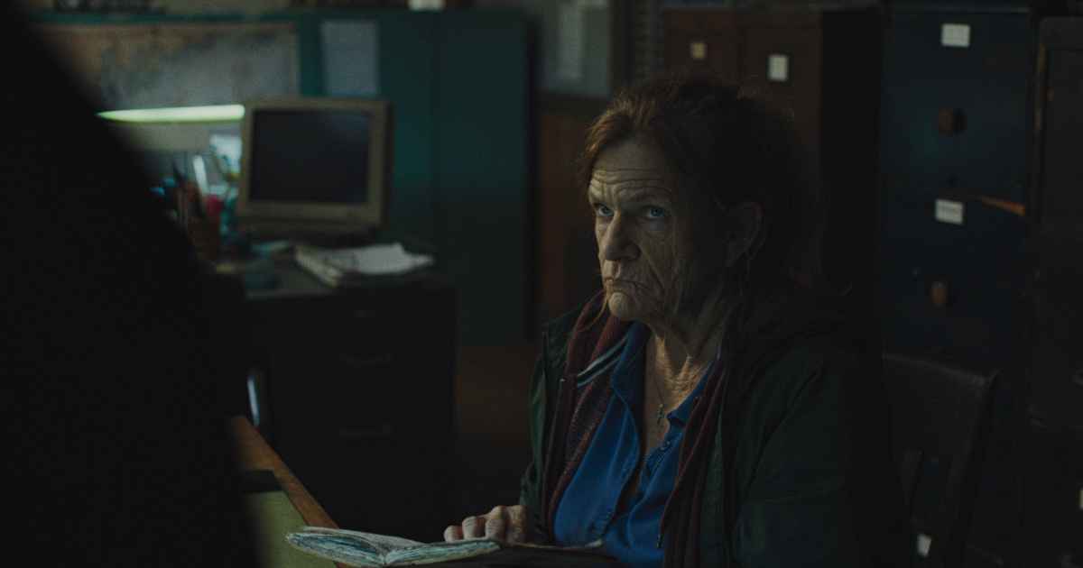 a woman in a desk at work looking upset seated